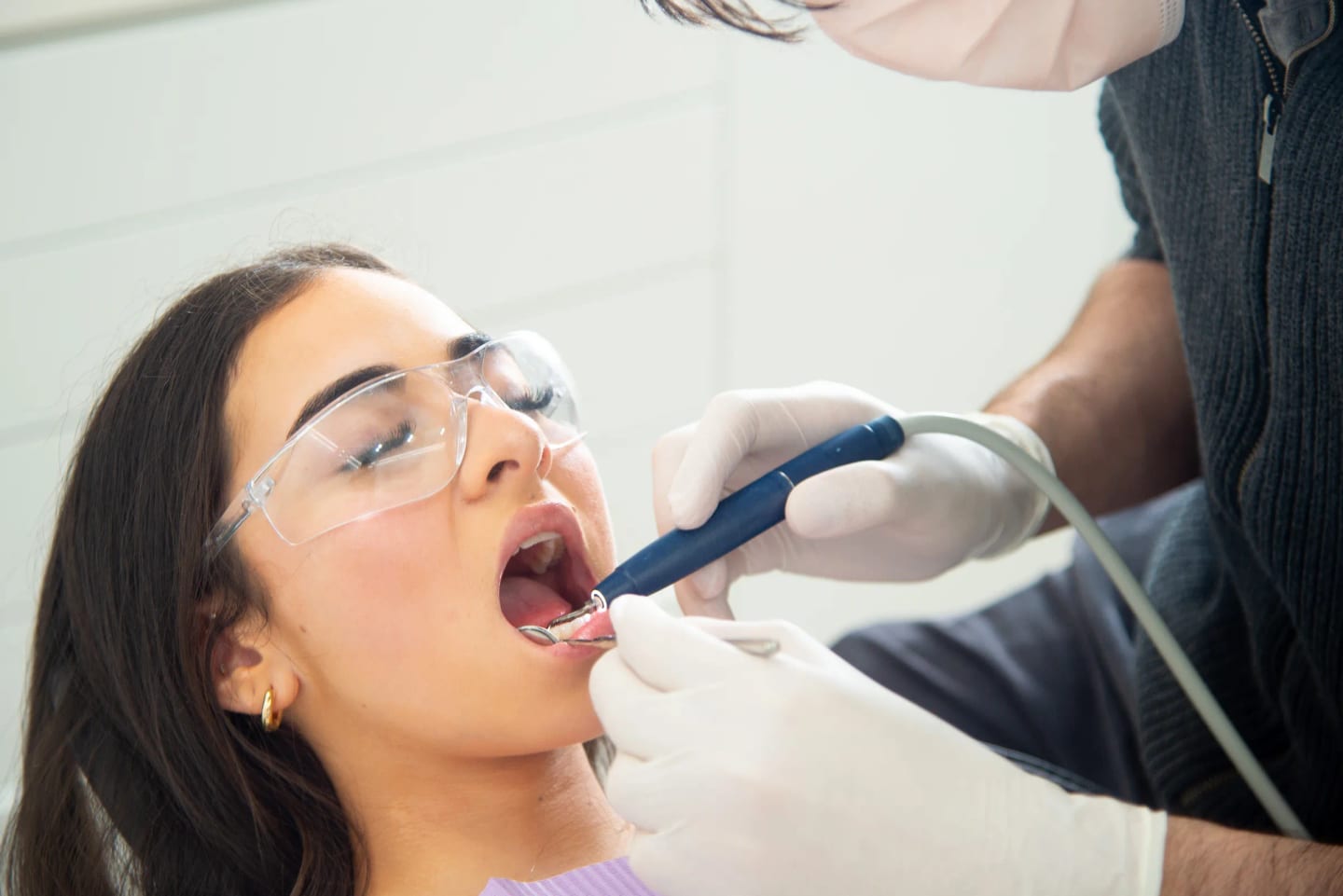 Dentist examining a tooth with a dental mirror