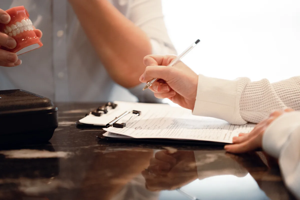 New patient completing paperwork before an Ivy Dental appointment